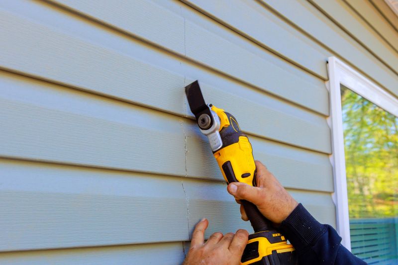 Professional Siding Installer Using Power Tools